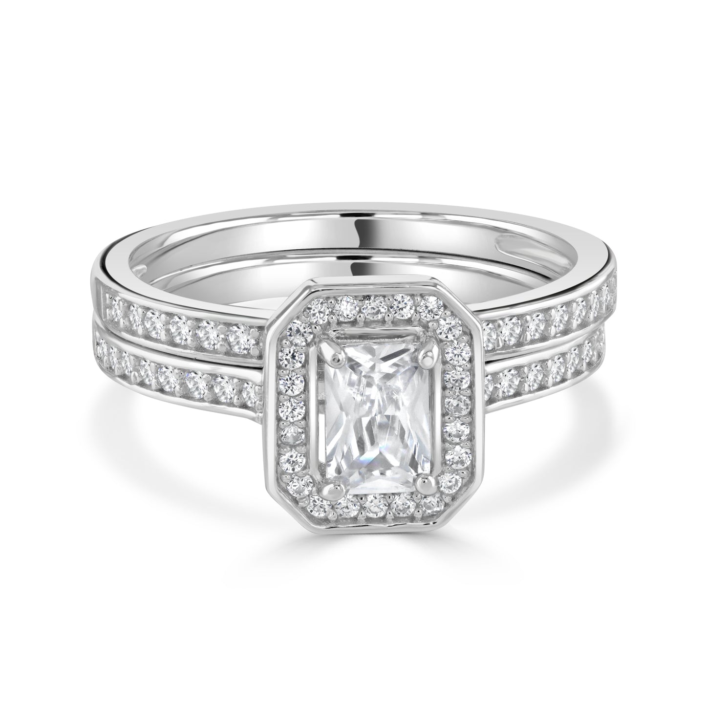 Two matching silver rings stacked together with emerald shaped gemstone and smaller clusters of cubic zirconia stones.