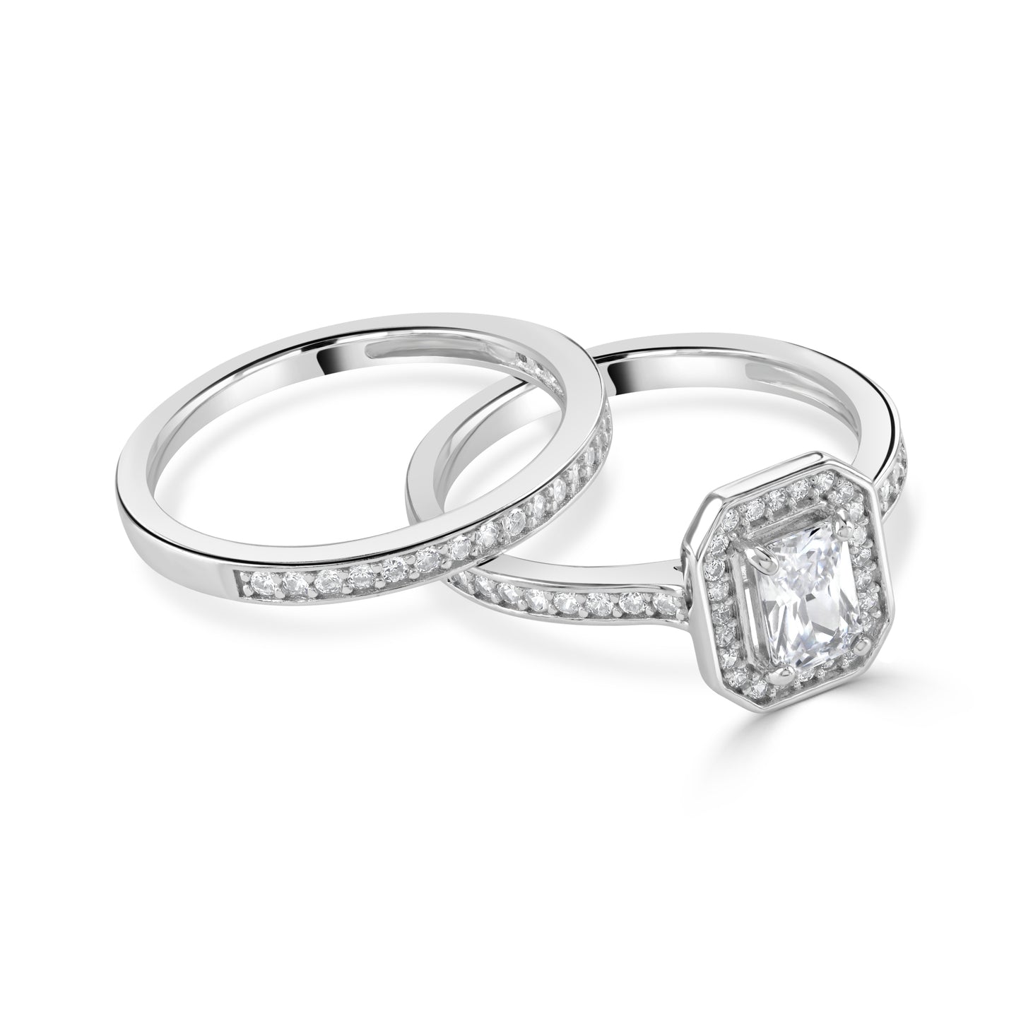Two matching cubic zirconia gemstone rings, an emerald cut and a half eternity ring in silver.