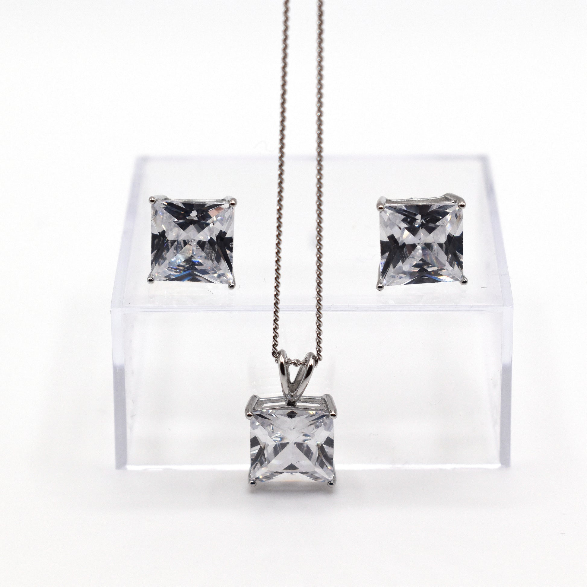 Clear cubic zirconia square cut gemstones on a pendant necklace with matching stud earrings. 