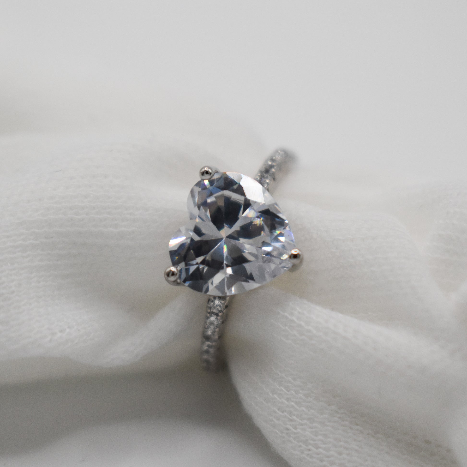 A beautiful ring with a heart shaped head made from cubic zirconia and 925 sterling silver with a rhodium plated finish.